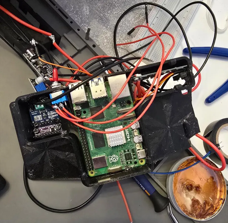 The controller's Pi 5 and wiring inside the printed case